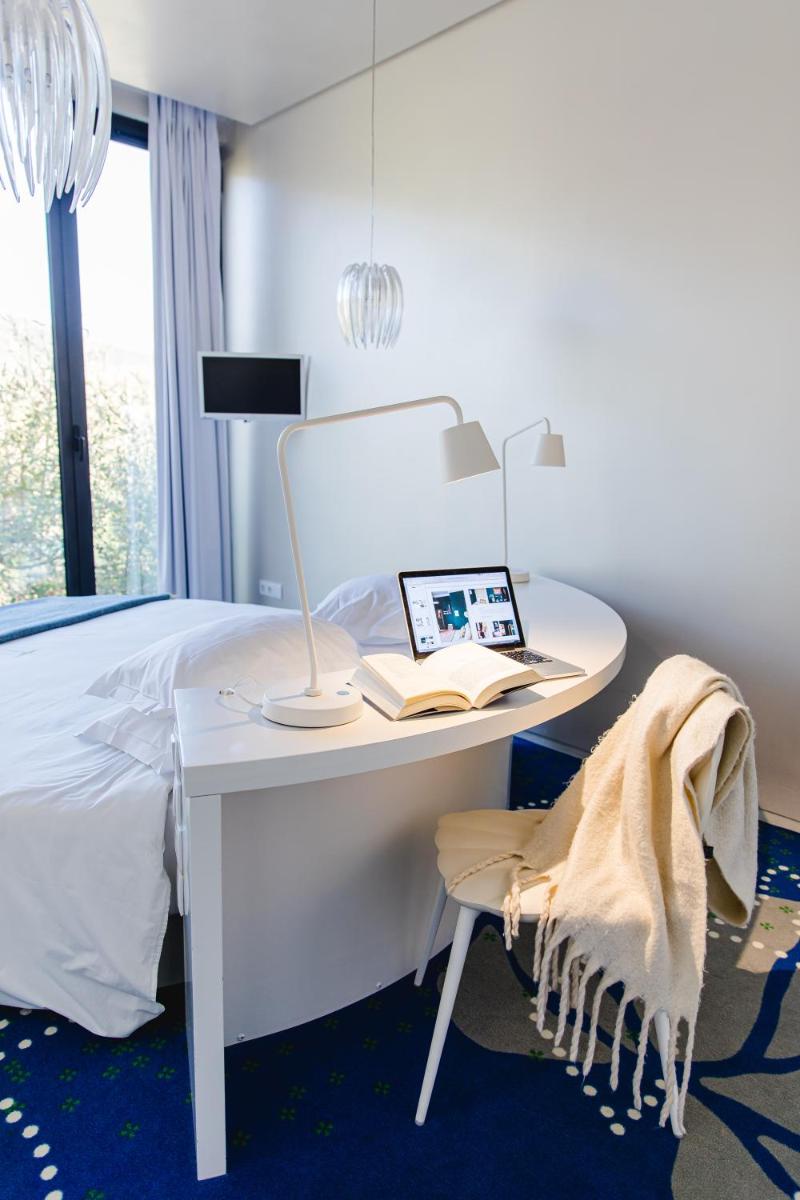 Uma cama ou camas num quarto em Cooking and Nature - Emotional Hotel