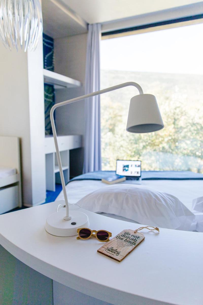 Uma cama ou camas num quarto em Cooking and Nature - Emotional Hotel