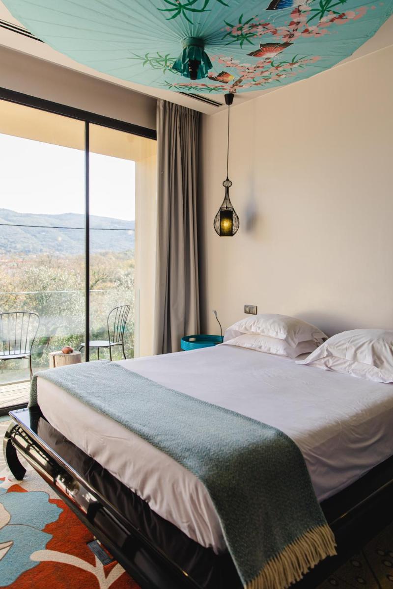 Uma cama ou camas num quarto em Cooking and Nature - Emotional Hotel