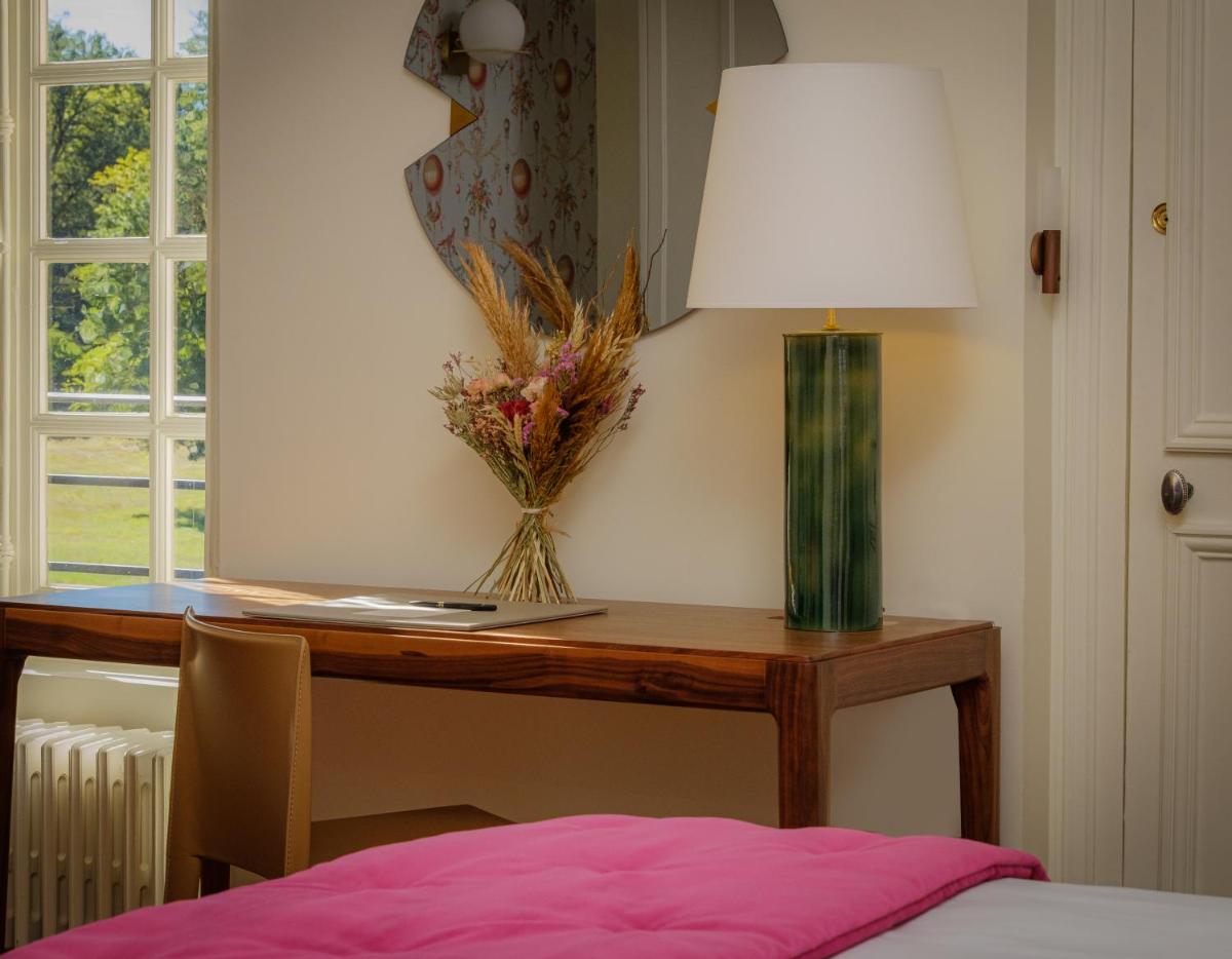 Un ou plusieurs lits dans un hébergement de l'établissement La Borde en Sologne Château & Spa