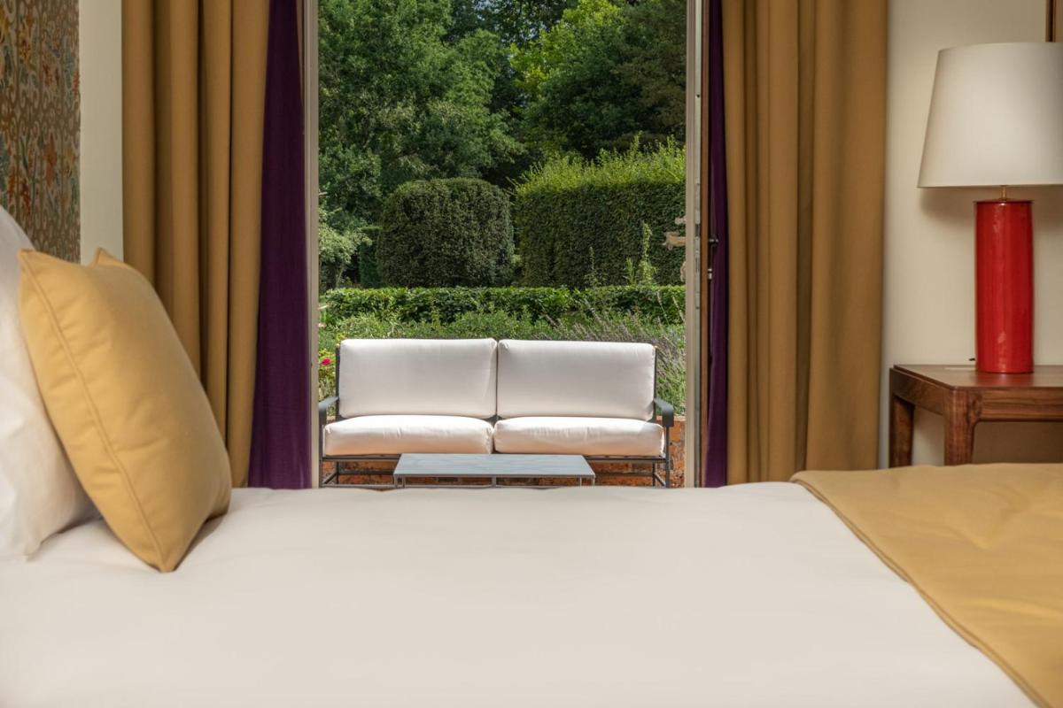Un ou plusieurs lits dans un hébergement de l'établissement La Borde en Sologne Château & Spa