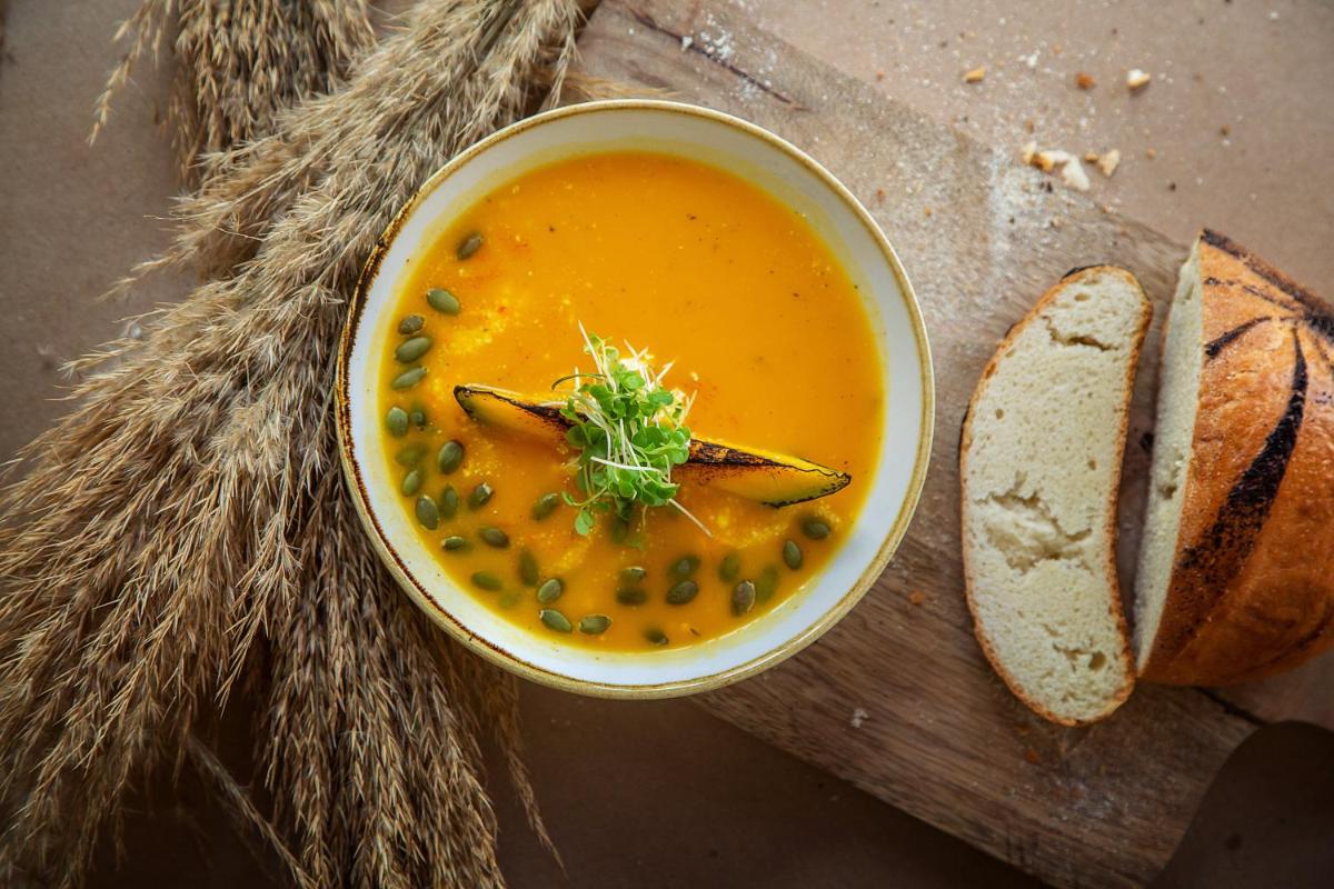 a bowl of soup with peas and a slice of bread at Hyatt Regency Jaipur Mansarovar in Jaipur a bowl of soup with peas and a slice of bread at Hyatt Regency Jaipur Mansarovar in Jaipur