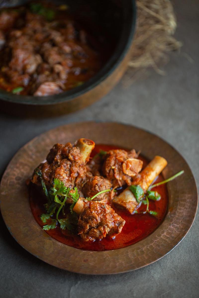 a plate of food with meat and vegetables on a table at Hyatt Regency Jaipur Mansarovar in Jaipur a plate of food with meat and vegetables on a table at Hyatt Regency Jaipur Mansarovar in Jaipur
