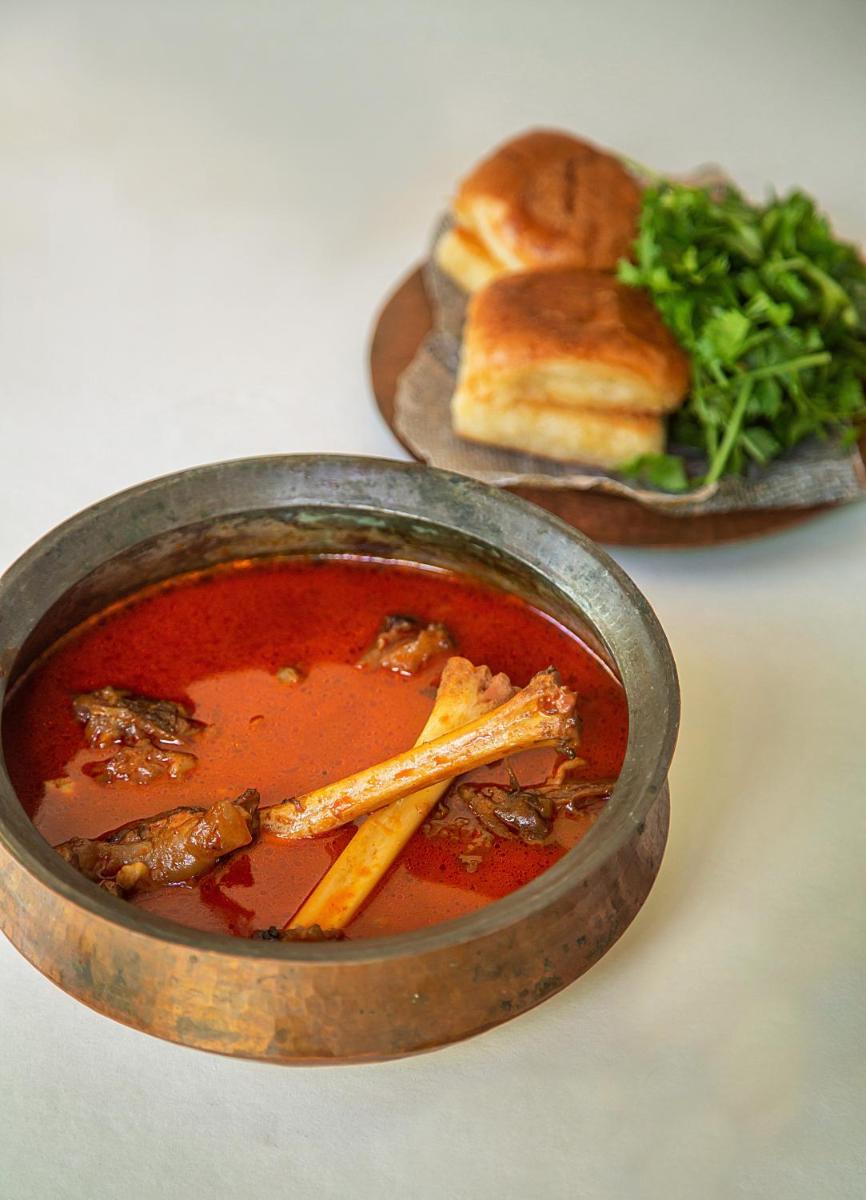 a bowl of soup with a sandwich and a plate of food at Hyatt Regency Jaipur Mansarovar in Jaipur a bowl of soup with a sandwich and a plate of food at Hyatt Regency Jaipur Mansarovar in Jaipur