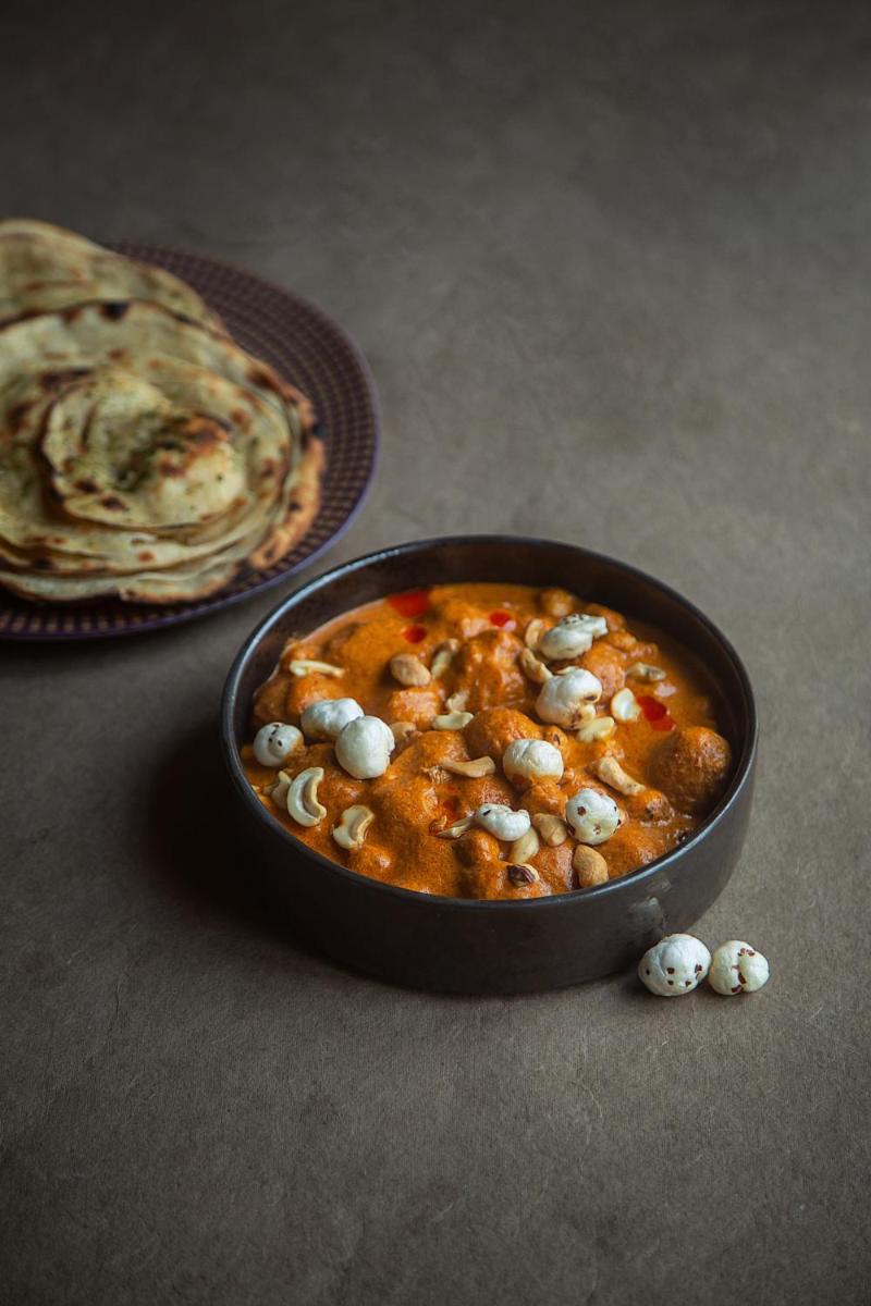 a black bowl of food with mushrooms on a table at Hyatt Regency Jaipur Mansarovar in Jaipur a black bowl of food with mushrooms on a table at Hyatt Regency Jaipur Mansarovar in Jaipur