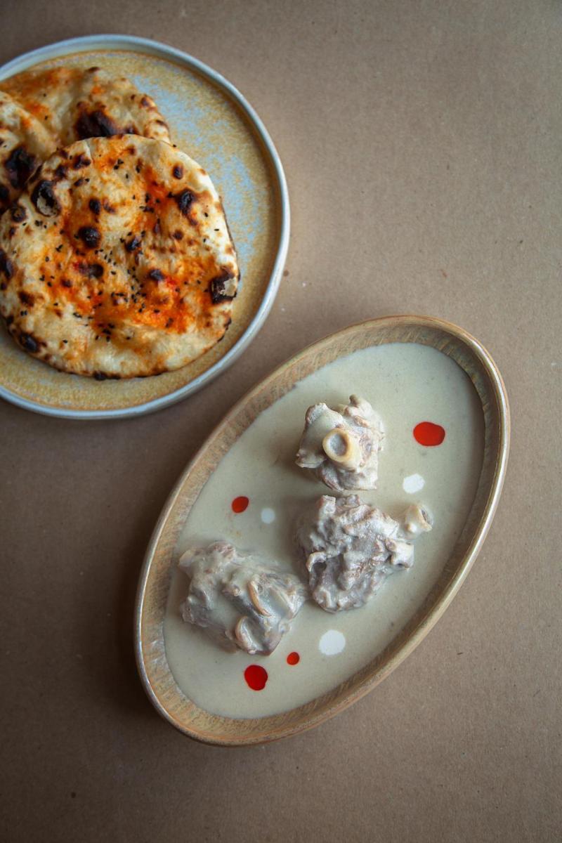 two plates of food on a table with a pizza at Hyatt Regency Jaipur Mansarovar in Jaipur two plates of food on a table with a pizza at Hyatt Regency Jaipur Mansarovar in Jaipur