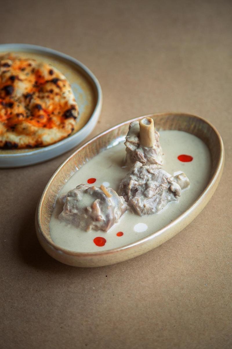 a plate of food on a table with a pizza at Hyatt Regency Jaipur Mansarovar in Jaipur a plate of food on a table with a pizza at Hyatt Regency Jaipur Mansarovar in Jaipur