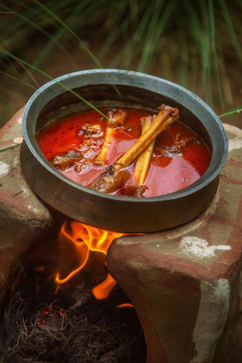 a pot of soup sitting on top of a fire at Hyatt Regency Jaipur Mansarovar in Jaipur a pot of soup sitting on top of a fire at Hyatt Regency Jaipur Mansarovar in Jaipur