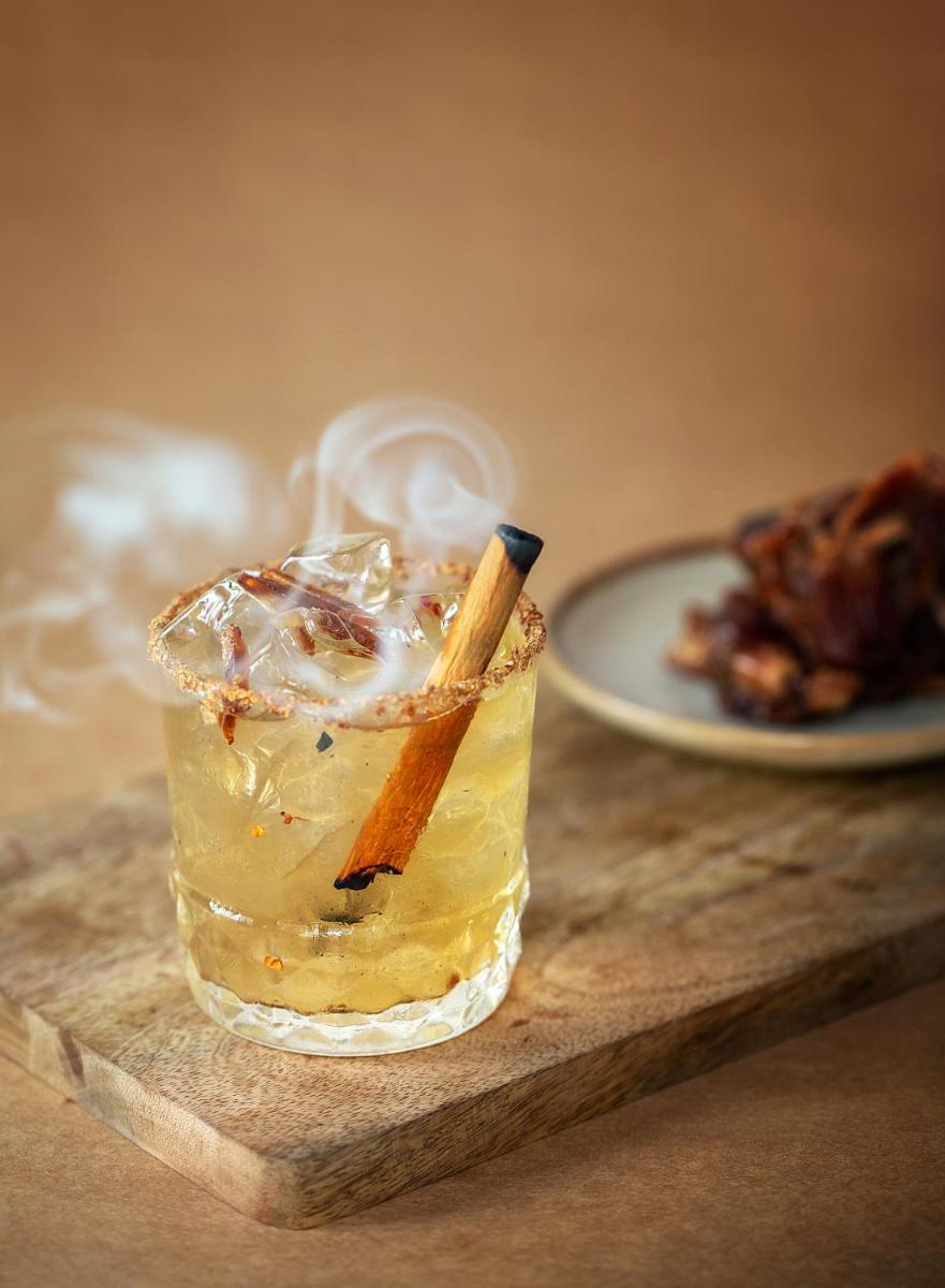 a drink with a cigarette in it sitting on a table at Hyatt Regency Jaipur Mansarovar in Jaipur a drink with a cigarette in it sitting on a table at Hyatt Regency Jaipur Mansarovar in Jaipur