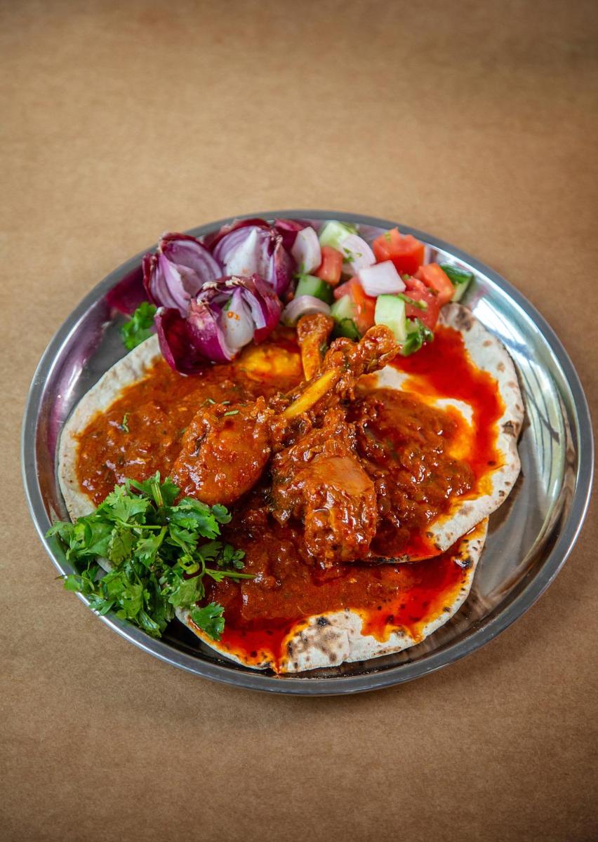 a plate of food with meat and vegetables on a table at Hyatt Regency Jaipur Mansarovar in Jaipur a plate of food with meat and vegetables on a table at Hyatt Regency Jaipur Mansarovar in Jaipur