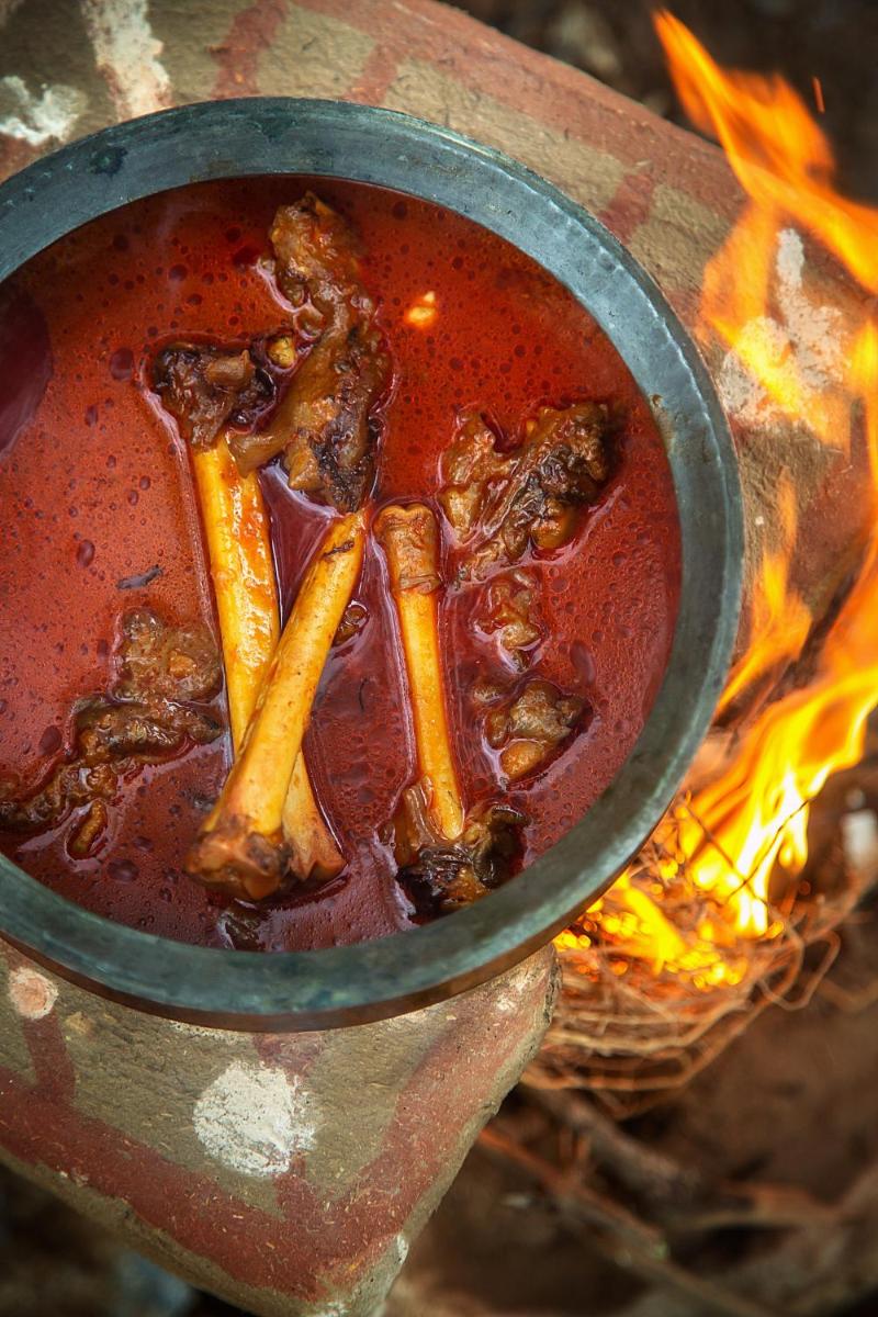 a pot of food sitting on top of a fire at Hyatt Regency Jaipur Mansarovar in Jaipur a pot of food sitting on top of a fire at Hyatt Regency Jaipur Mansarovar in Jaipur