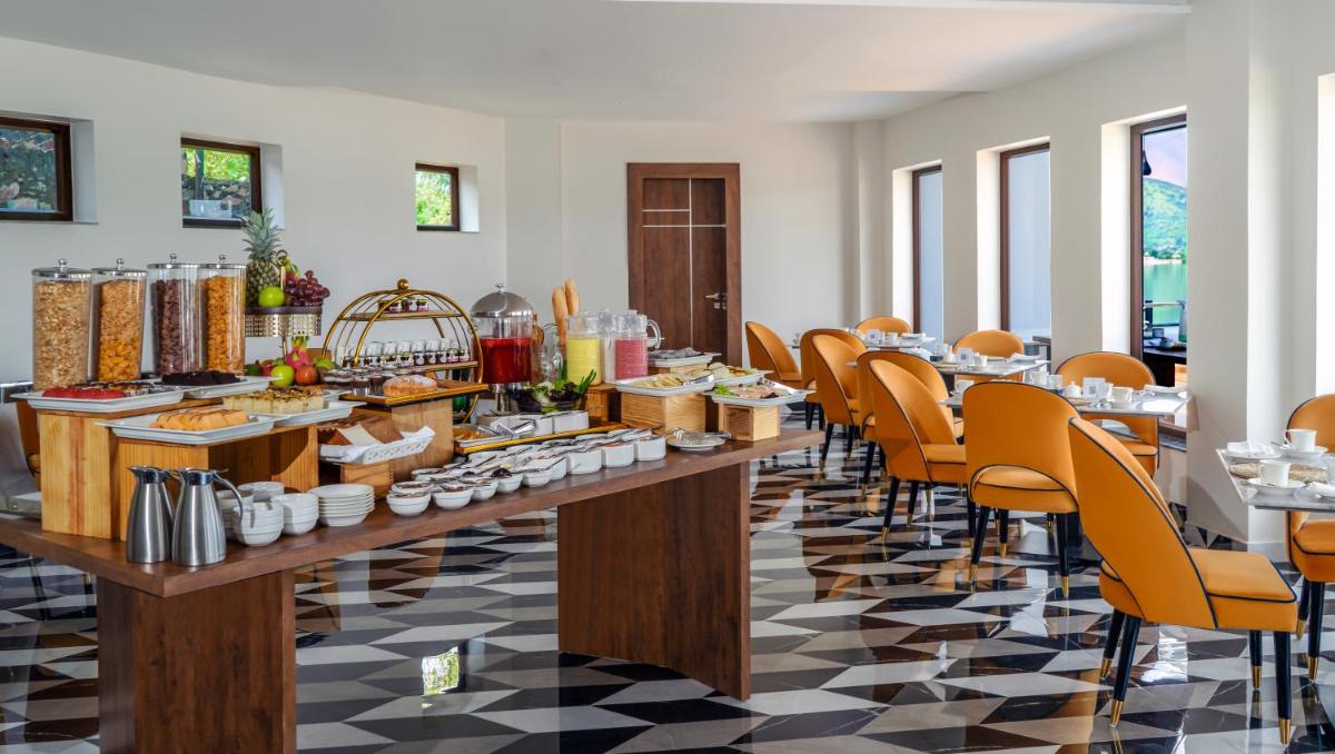 a breakfast buffet in a room with tables and chairs at ZANA Lakeview Resort - most scenic lakeside resort in Udaipur