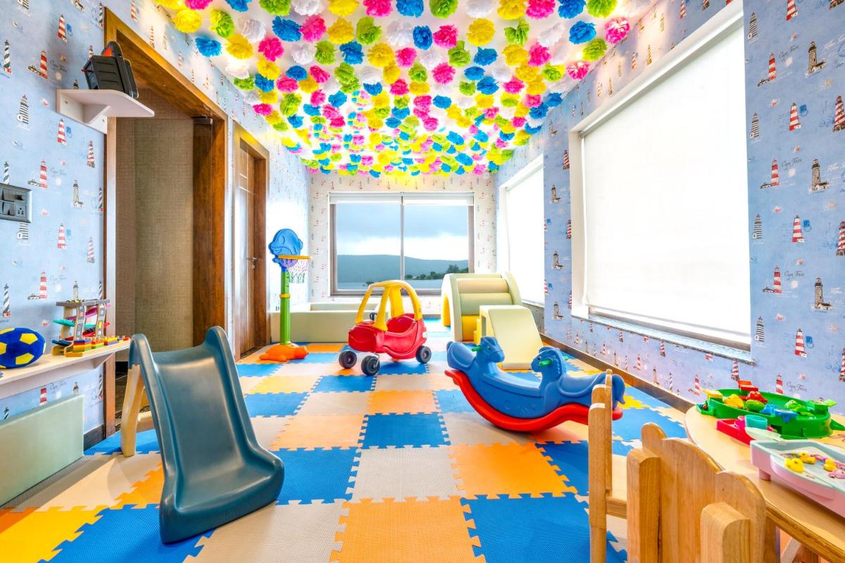 a childs play room with toys and balloons on the ceiling at ZANA Lakeview Resort - most scenic lakeside resort in Udaipur