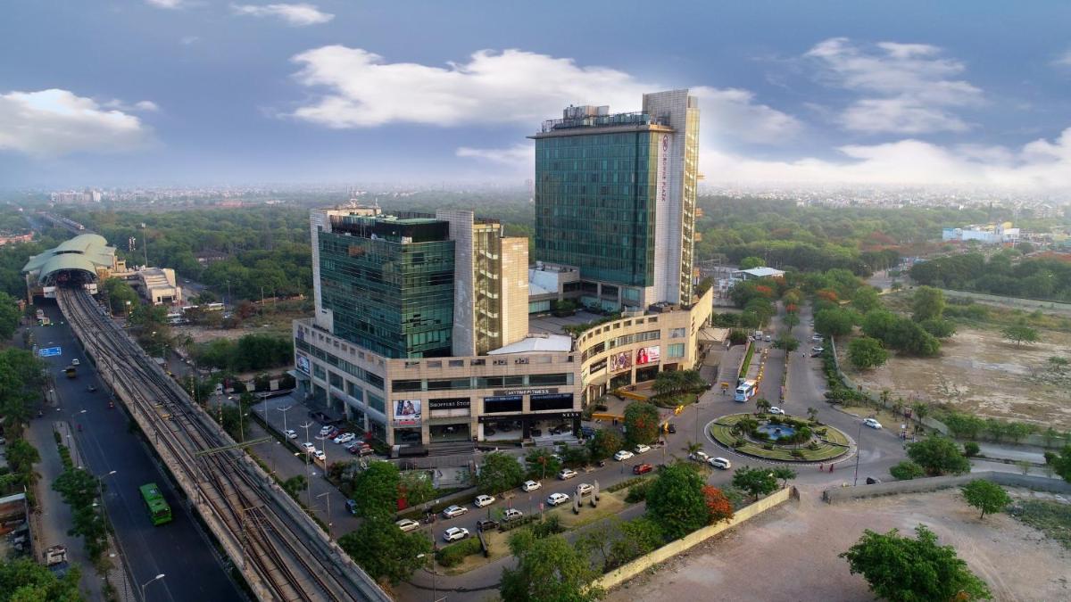 an aerial view of a city with a tall building at Crowne Plaza New Delhi Rohini by IHG in New Delhi an aerial view of a city with a tall building at Crowne Plaza New Delhi Rohini by IHG in New Delhi
