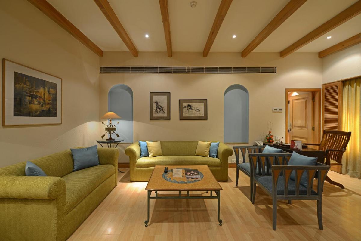 a living room with two couches and a table at Sun-n-Sand Mumbai Juhu Beach in Mumbai