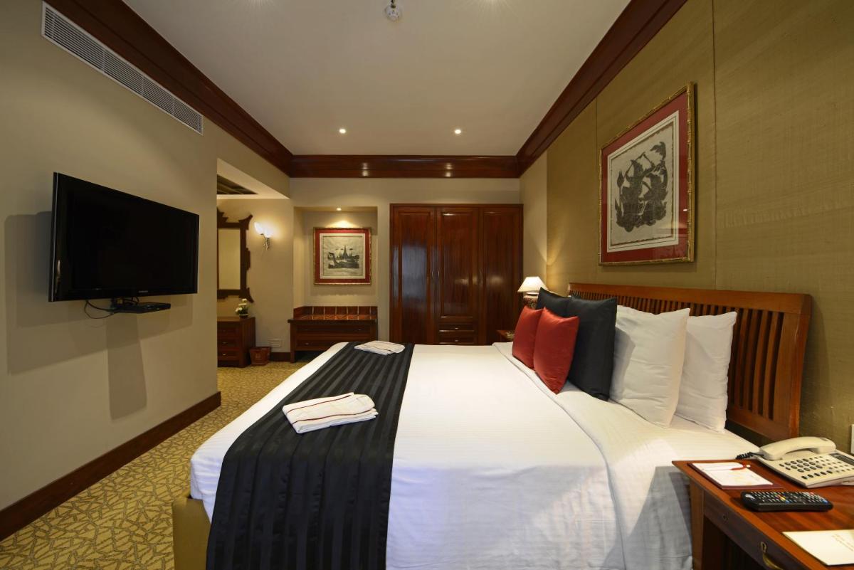 a hotel room with a bed and a television at Sun-n-Sand Mumbai Juhu Beach in Mumbai