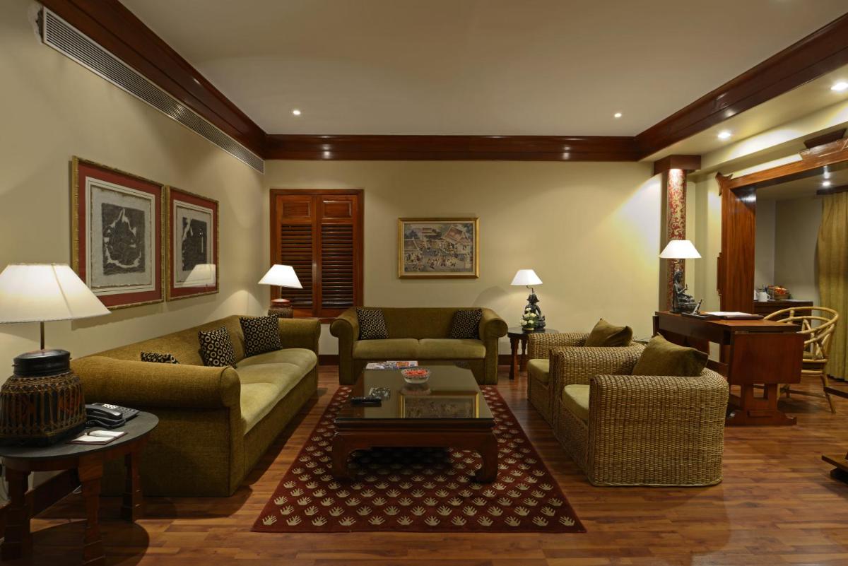 a living room with couches and a piano at Sun-n-Sand Mumbai Juhu Beach in Mumbai
