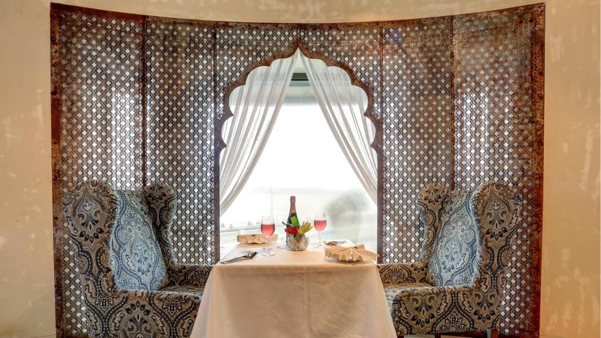 a dining room with a table and a window at InterContinental Marine Drive Mumbai by IHG in Mumbai