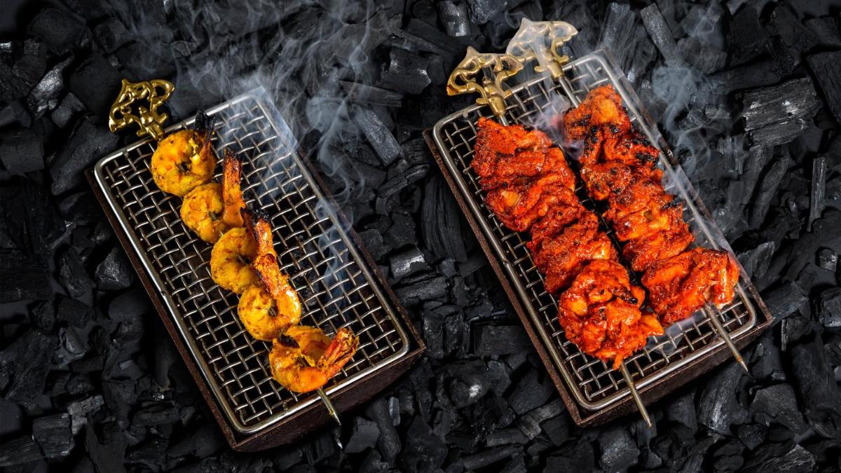 two baskets of chicken on skewers on a grill at InterContinental Marine Drive Mumbai by IHG in Mumbai