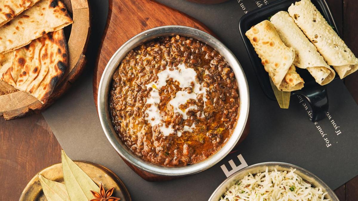 a table with a bowl of chili and some bread at InterContinental Marine Drive Mumbai by IHG in Mumbai