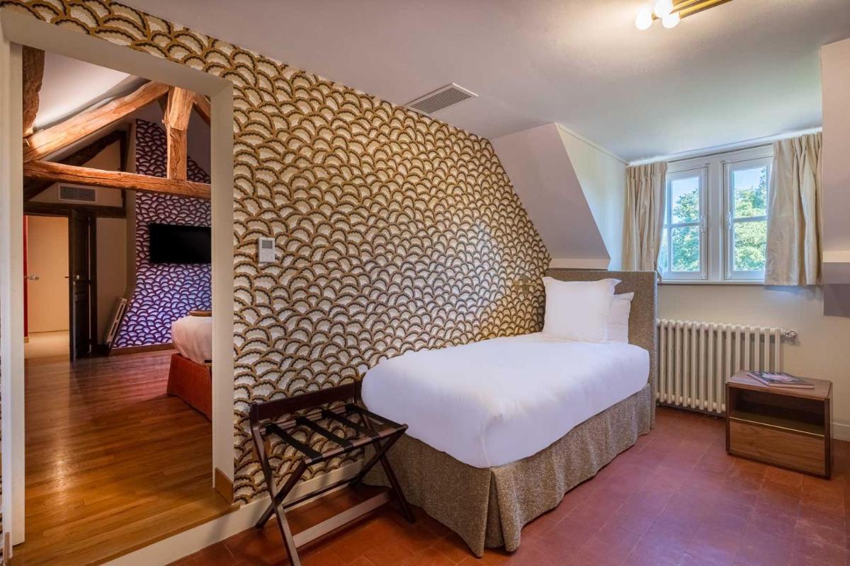 Un ou plusieurs lits dans un hébergement de l'établissement La Borde en Sologne Château & Spa