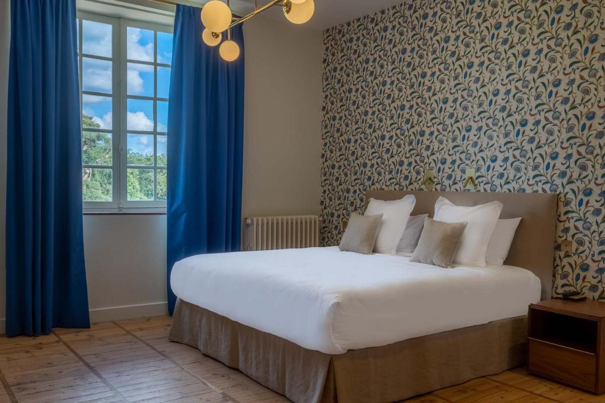 Un ou plusieurs lits dans un hébergement de l'établissement La Borde en Sologne Château & Spa