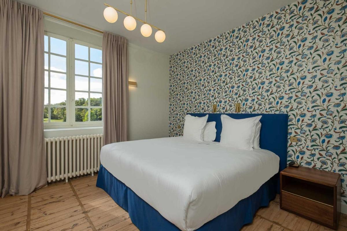 Un ou plusieurs lits dans un hébergement de l'établissement La Borde en Sologne Château & Spa