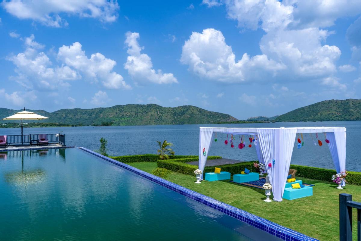 a wedding set up by the swimming pool at a resort at ZANA Lakeview Resort - most scenic lakeside resort in Udaipur