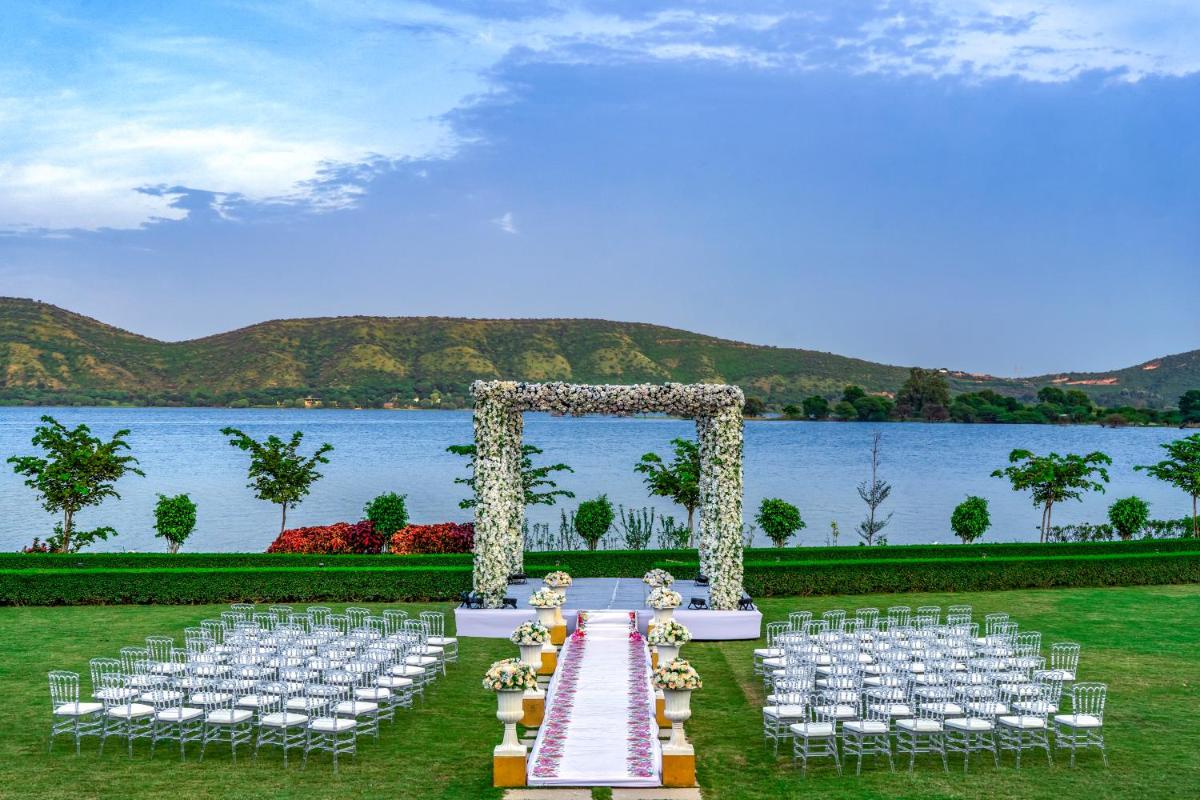 a wedding set up in front of the water at ZANA Lakeview Resort - most scenic lakeside resort in Udaipur