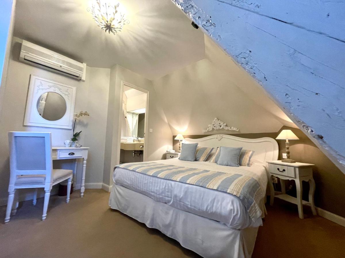 Un ou plusieurs lits dans un hébergement de l'établissement Château Hôtel Edward 1er