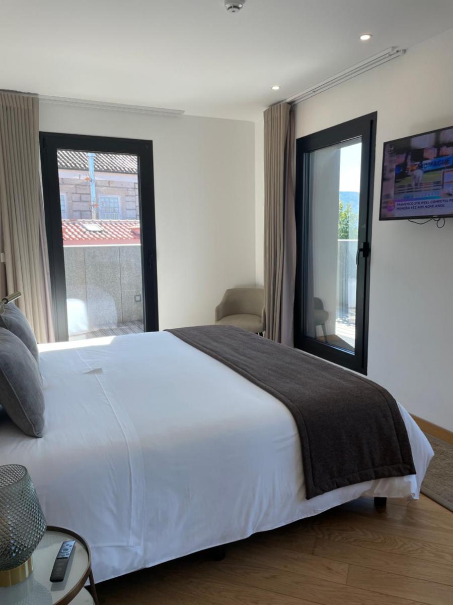 Uma cama ou camas num quarto em Castelo Hotel