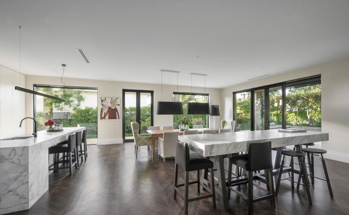 A stunning kitchen featuring marble bench tops - Housity