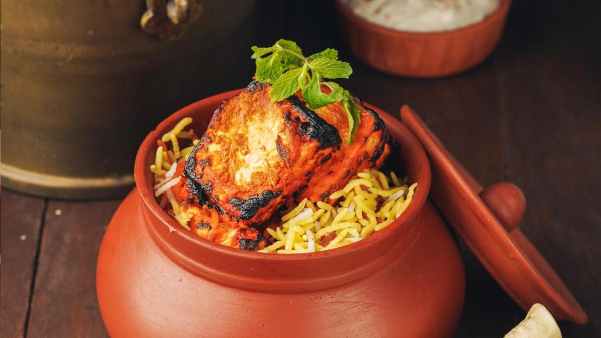 a bowl of food with a chicken on top of noodles at InterContinental Marine Drive Mumbai by IHG in Mumbai