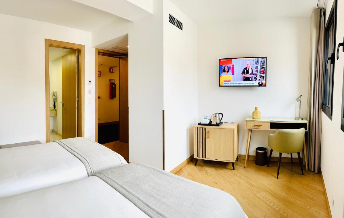 Uma cama ou camas num quarto em Castelo Hotel
