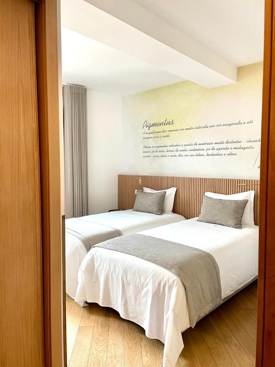 Uma cama ou camas num quarto em Castelo Hotel