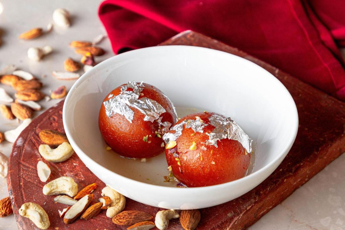 two chocolate covered strawberries in a white bowl on a cutting board at Crowne Plaza New Delhi Rohini by IHG in New Delhi two chocolate covered strawberries in a white bowl on a cutting board at Crowne Plaza New Delhi Rohini by IHG in New Delhi