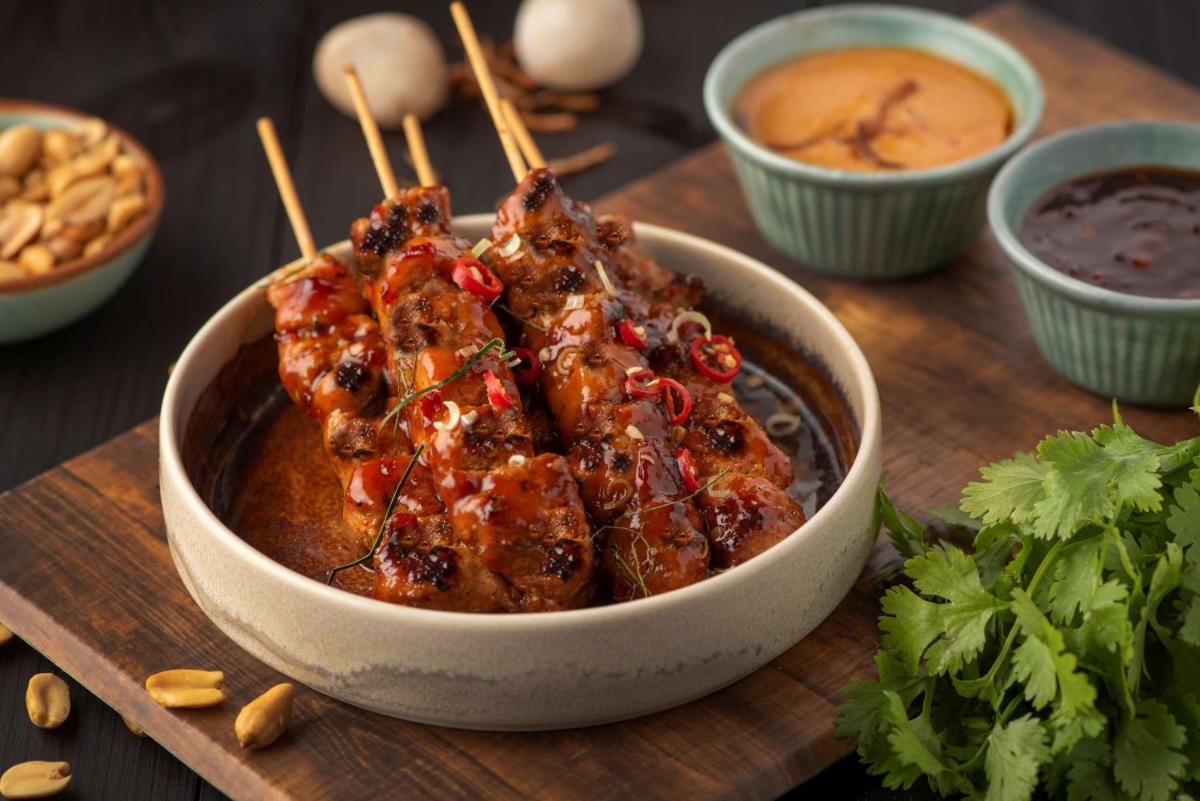 a bowl of food on a wooden cutting board at Radisson Blu Plaza Delhi Airport in New Delhi a bowl of food on a wooden cutting board at Radisson Blu Plaza Delhi Airport in New Delhi