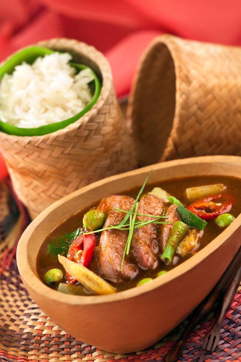 a wooden bowl of food with meat and vegetables at Radisson Blu Plaza Delhi Airport in New Delhi a wooden bowl of food with meat and vegetables at Radisson Blu Plaza Delhi Airport in New Delhi