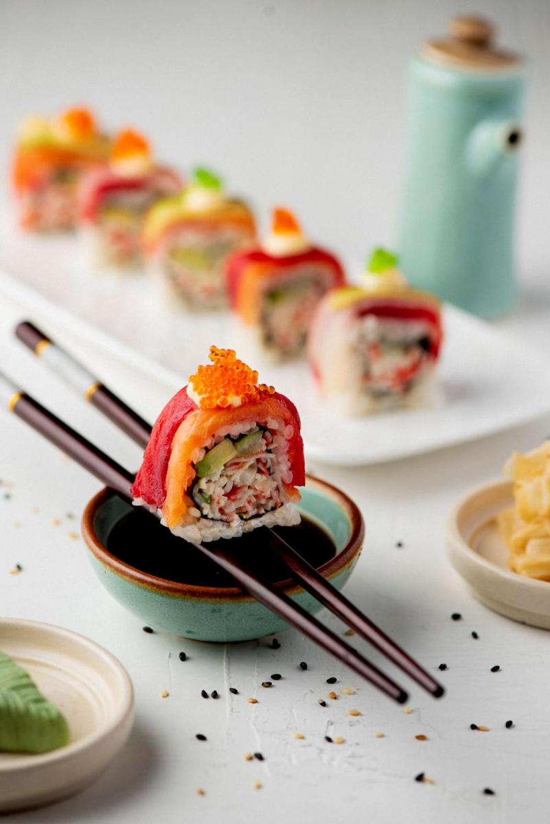 a piece of sushi in a bowl with chopsticks at Radisson Blu Plaza Delhi Airport in New Delhi a piece of sushi in a bowl with chopsticks at Radisson Blu Plaza Delhi Airport in New Delhi