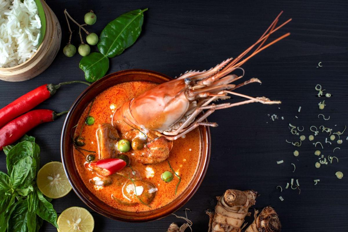 a plate of food with a shrimp in a sauce at Radisson Blu Plaza Delhi Airport in New Delhi a plate of food with a shrimp in a sauce at Radisson Blu Plaza Delhi Airport in New Delhi