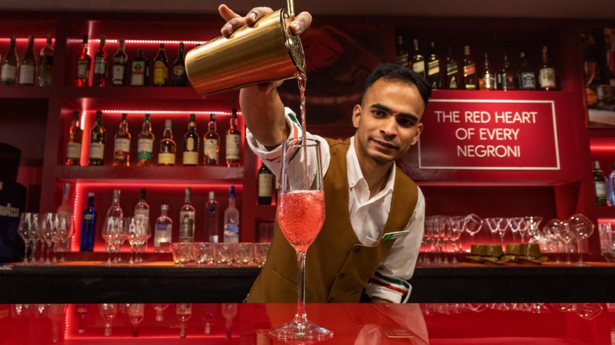 a bartender preparing a red heart of few nephew cocktail at Holiday Inn New Delhi Aerocity by IHG in New Delhi