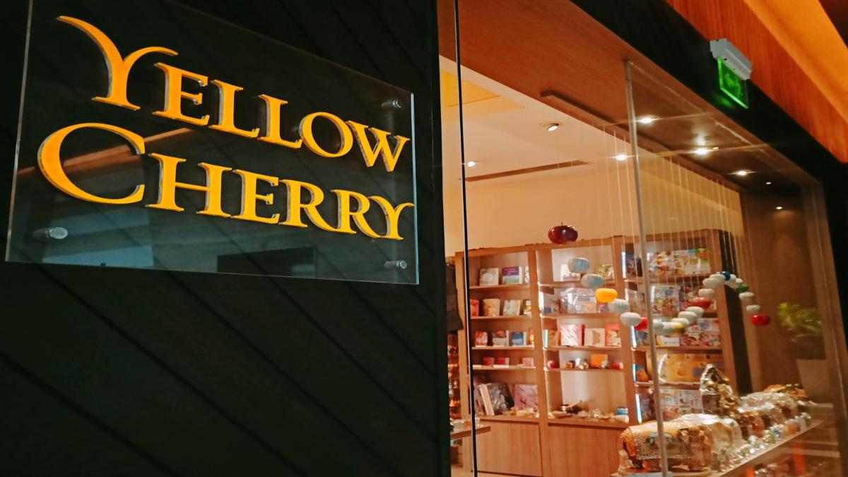 a window of a store with a yellow sign on it at Holiday Inn New Delhi Aerocity by IHG in New Delhi
