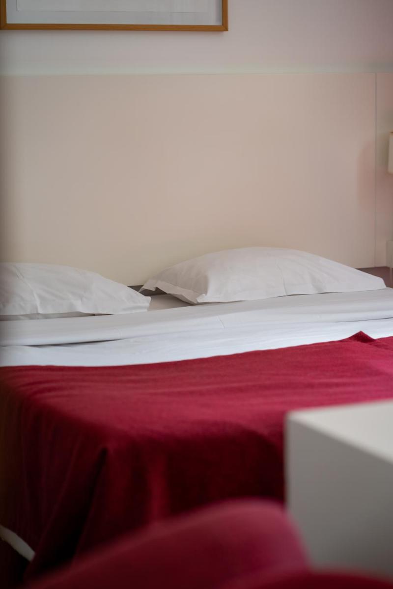 Uma cama ou camas num quarto em Hotel Vila D'Óbidos