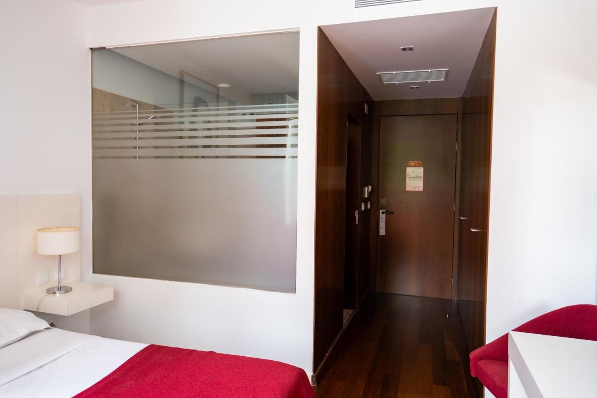 Uma cama ou camas num quarto em Hotel Vila D'Óbidos