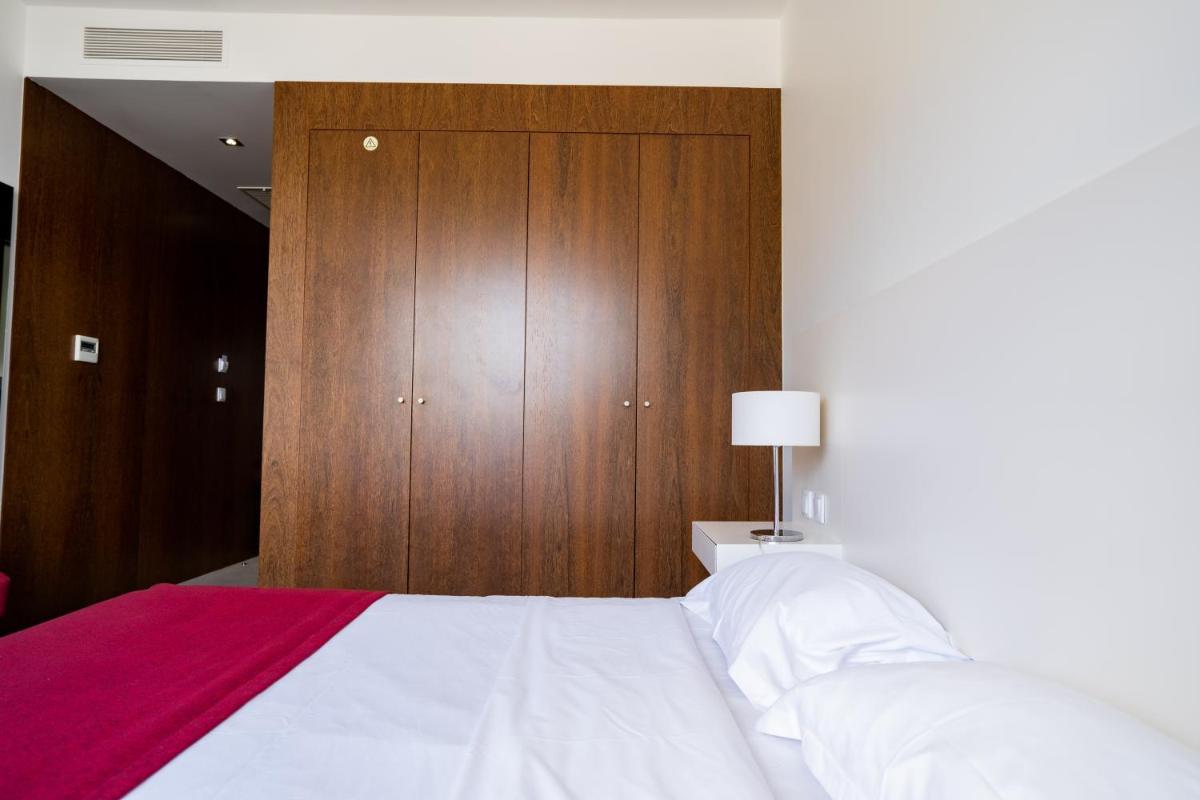 Uma cama ou camas num quarto em Hotel Vila D'Óbidos