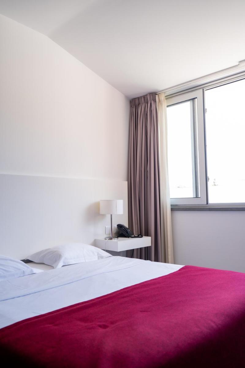 Uma cama ou camas num quarto em Hotel Vila D'Óbidos