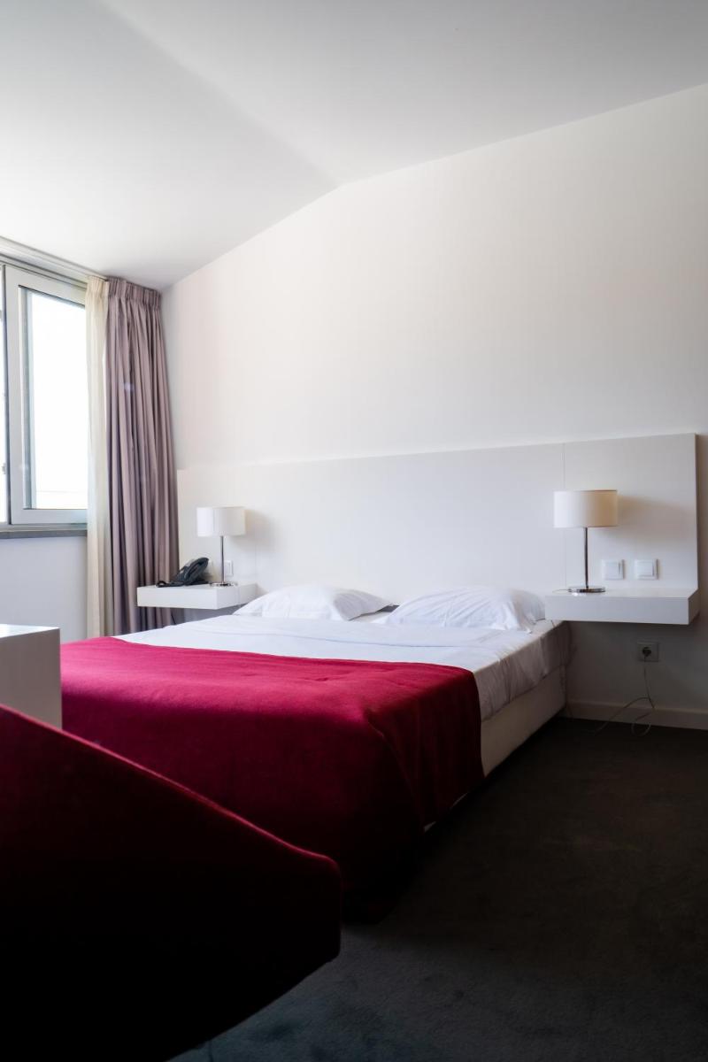 Uma cama ou camas num quarto em Hotel Vila D'Óbidos
