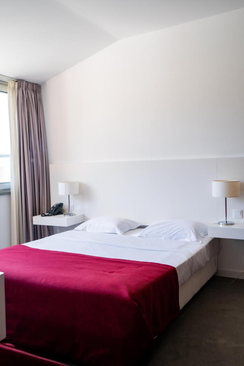 Uma cama ou camas num quarto em Hotel Vila D'Óbidos