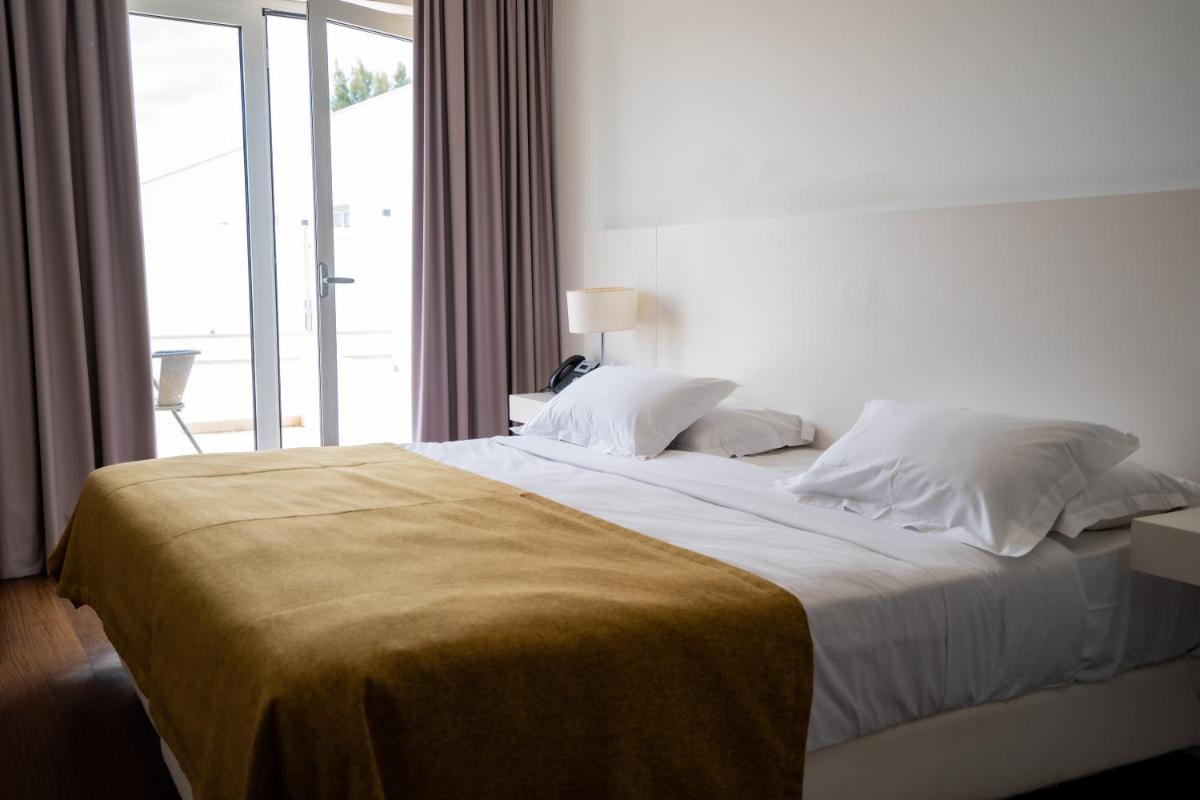 Uma cama ou camas num quarto em Hotel Vila D'Óbidos