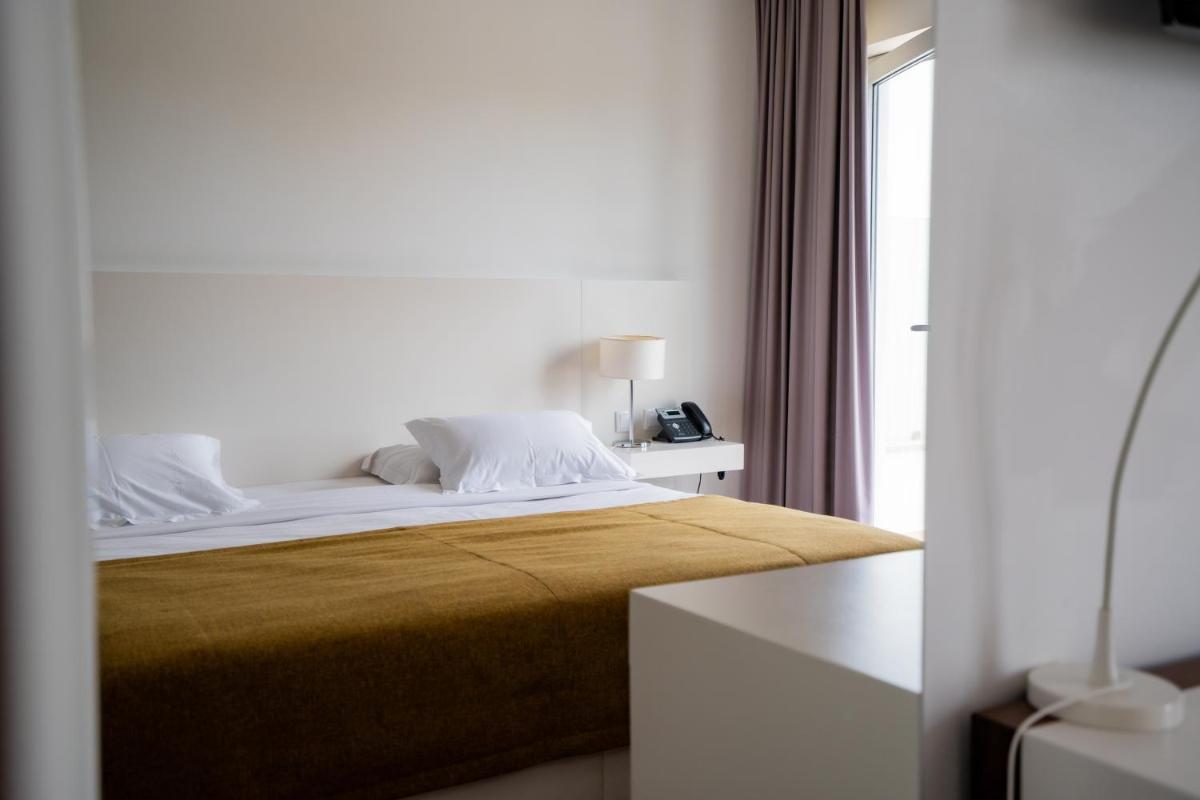 Uma cama ou camas num quarto em Hotel Vila D'Óbidos